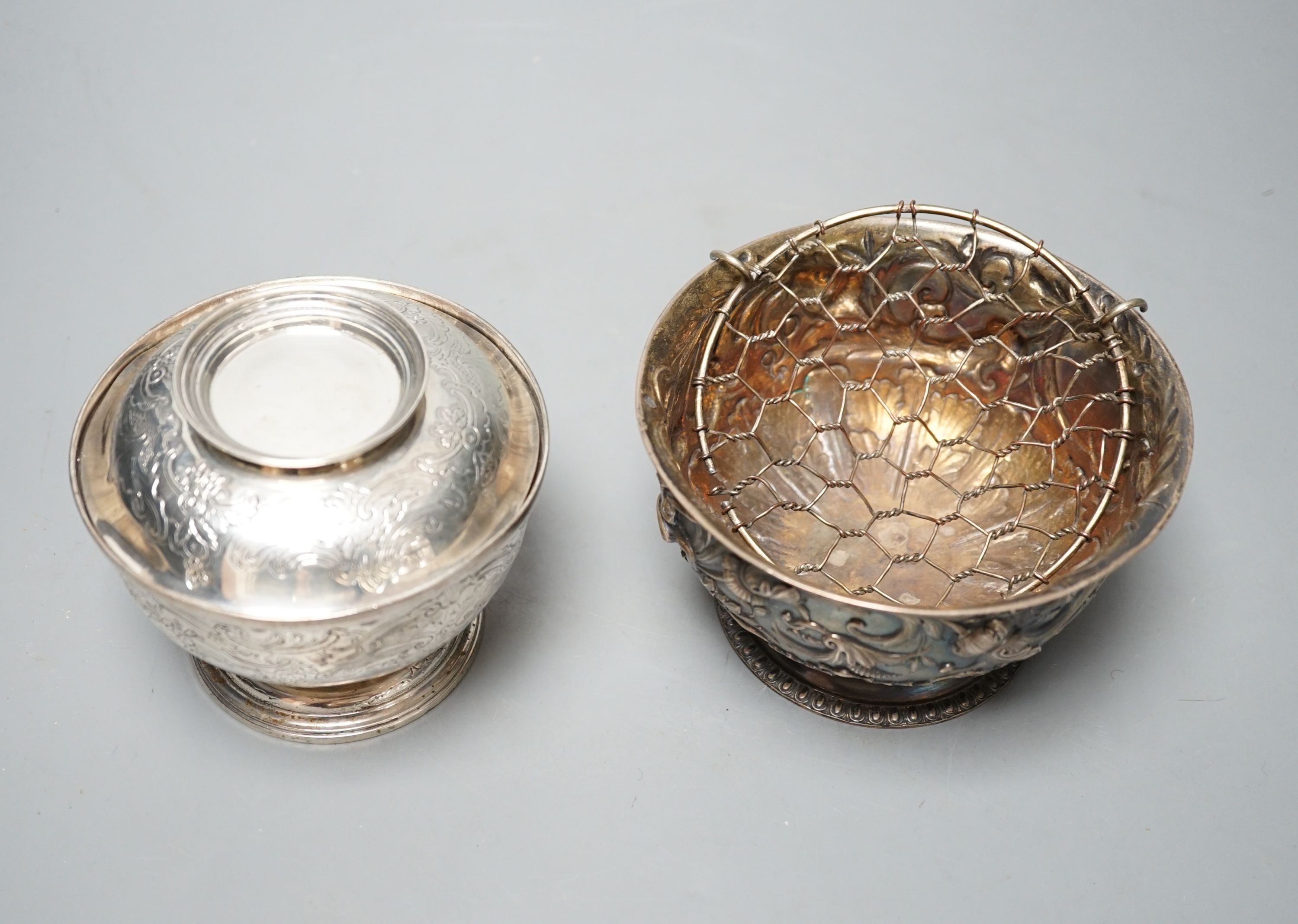 An Edwardian silver bowl, embossed with putto amid scrolls, London, 1902, diameter 13.1cm and a white metal bowl and cover, gross 20.5oz.
